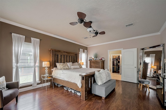 18914 Hikers Trail Dr, Humble, TX 77346 - bedroom featuring wood finished floors, crown molding, a spacious closet, baseboards, and ceiling fan