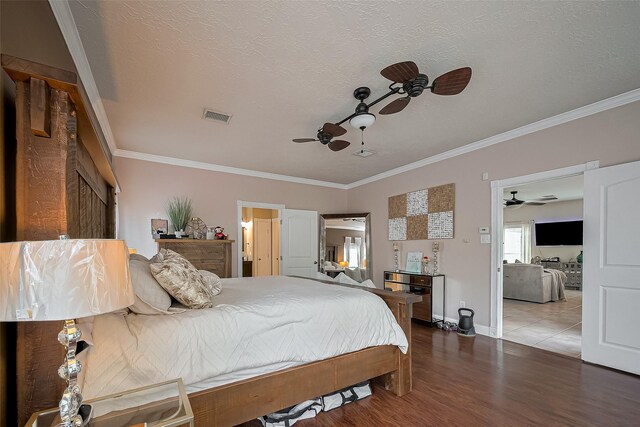 18914 Hikers Trail Dr, Humble, TX 77346 - bedroom featuring ornamental molding, wood finished floors, baseboards, ceiling fan, and a textured ceiling