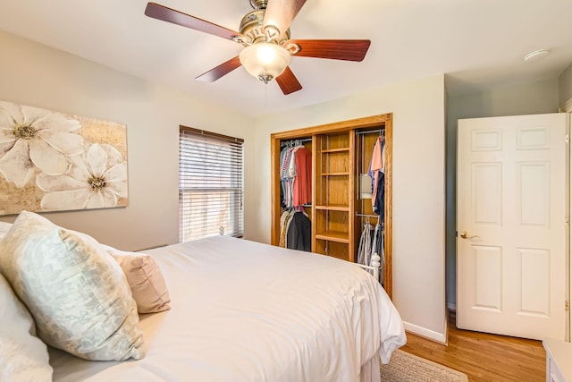 bedroom with light wood-type flooring, a closet, baseboards, and a ceiling fan