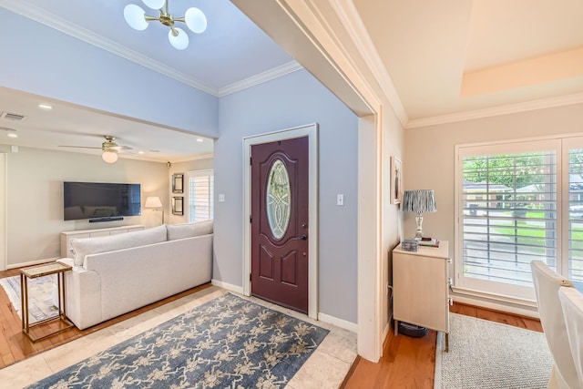 entrance foyer featuring baseboards, a chandelier, crown molding, light tile patterned flooring, and visible vents