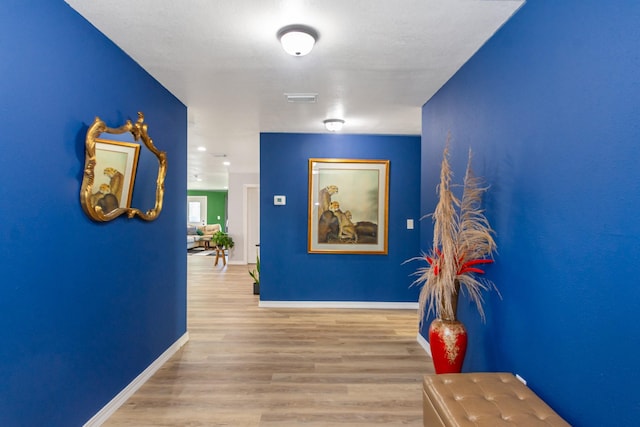 3718 Prudence Dr, Houston, TX 77045 - corridor featuring visible vents, baseboards, and wood finished floors