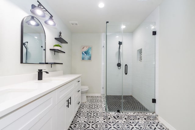 3718 Prudence Dr, Houston, TX 77045 - full bath featuring baseboards, double vanity, toilet, a shower stall, and a sink