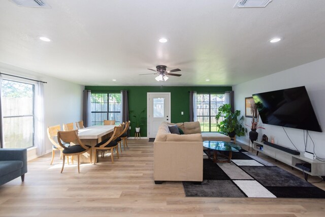 3718 Prudence Dr, Houston, TX 77045 - living room featuring light wood-style floors, visible vents, and recessed lighting