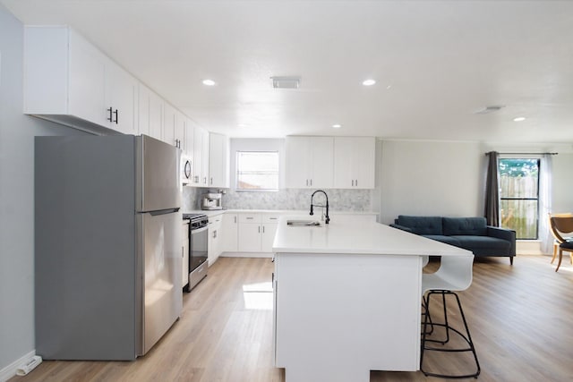 3718 Prudence Dr, Houston, TX 77045 - kitchen featuring freestanding refrigerator, gas range, a sink, open floor plan, and decorative backsplash