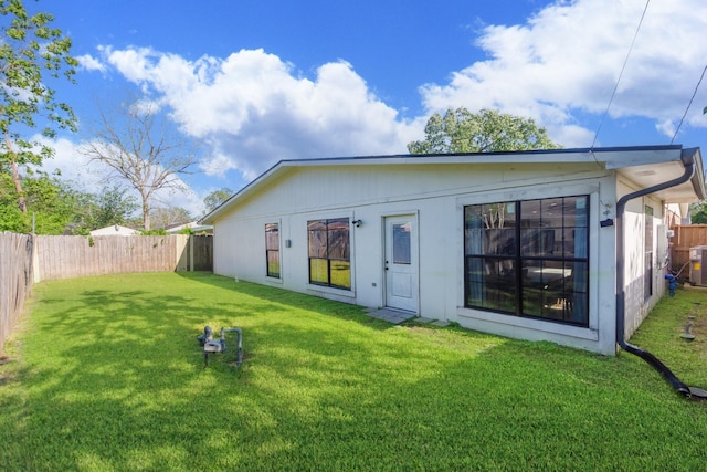3718 Prudence Dr, Houston, TX 77045 - rear view of property with a yard, a fenced backyard, and central AC