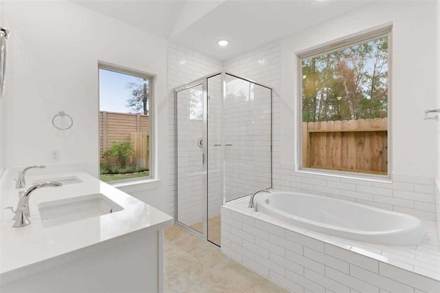 full bath featuring a sink, a bath, recessed lighting, and a stall shower