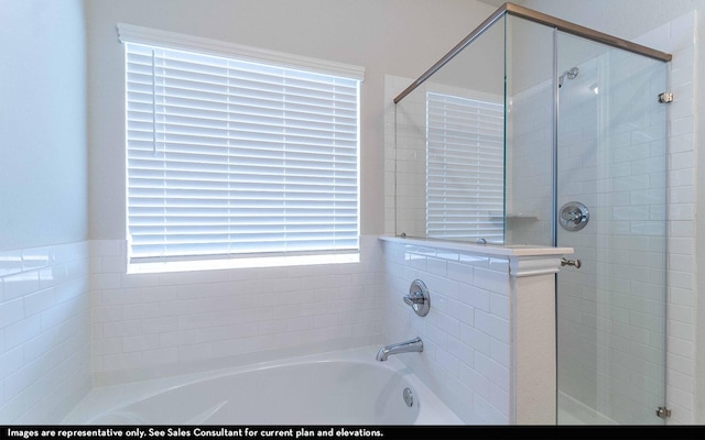 922 Alaska Cedar Dr, Crosby, TX 77532 - full bathroom featuring a shower stall, a bath, and healthy amount of natural light