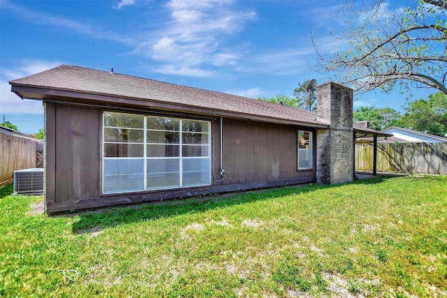 6902 Desert Rose Ln, Houston, TX 77086 - rear view of property featuring central air condition unit and a chimney