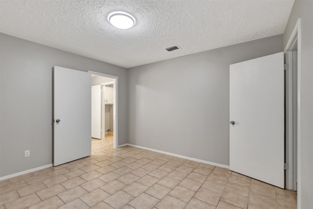 6902 Desert Rose Ln, Houston, TX 77086 - unfurnished bedroom with a textured ceiling and baseboards
