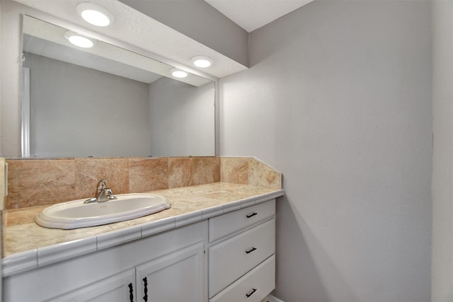 6902 Desert Rose Ln, Houston, TX 77086 - bathroom featuring vanity and decorative backsplash