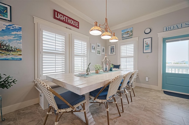 dining space with baseboards and ornamental molding