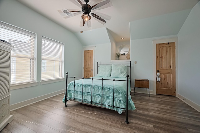 bedroom with visible vents, baseboards, a ceiling fan, vaulted ceiling, and wood finished floors