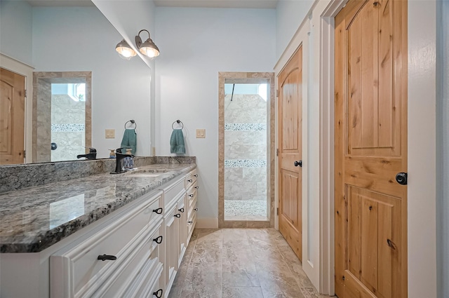 bathroom with a shower stall and vanity