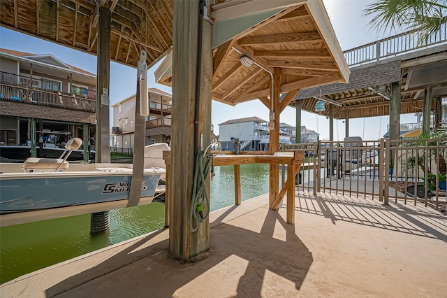 view of patio / terrace featuring a residential view and a water view