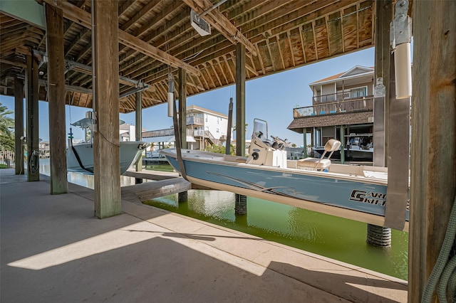 dock area with boat lift and a water view