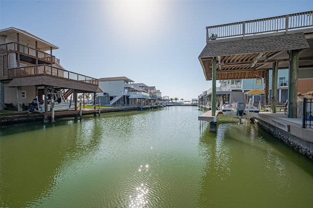 dock area with a residential view and a water view