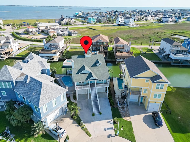 drone / aerial view with a residential view and a water view