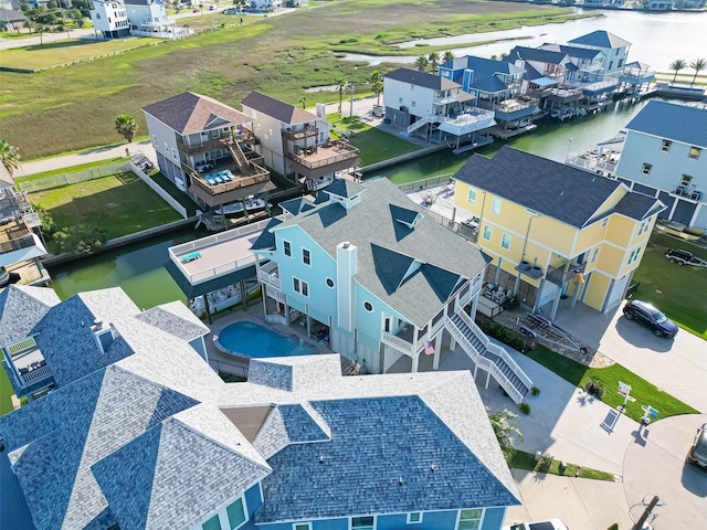drone / aerial view featuring a water view and a residential view