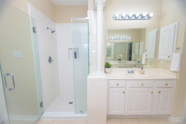 full bath featuring vanity, a shower stall, and tile patterned flooring
