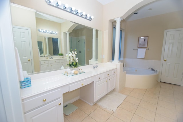 full bathroom featuring ornate columns, a shower stall, tile patterned flooring, and vanity