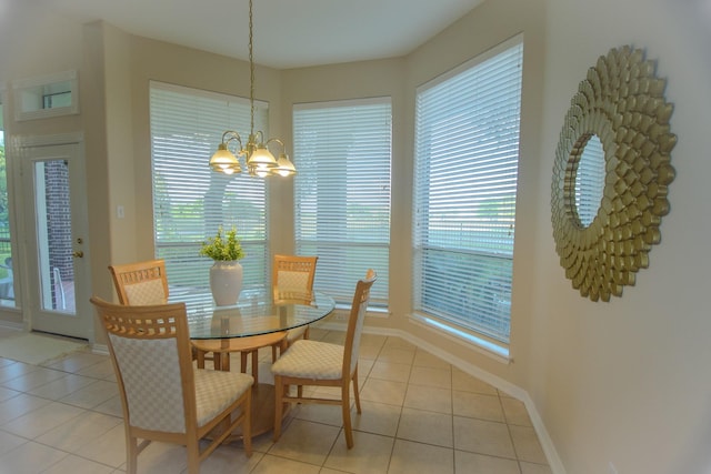 dining room featuring a chandelier, baseboards, and light tile patterned floors