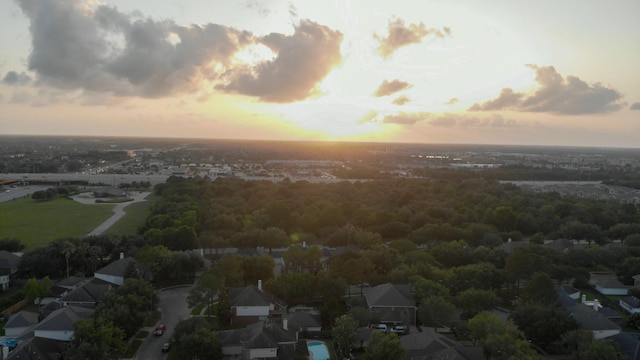 aerial view at dusk featuring a residential view