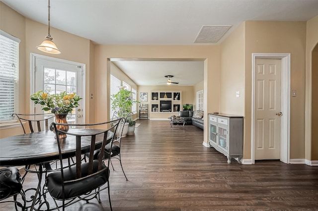 dining room featuring visible vents, dark wood-style flooring, ceiling fan, and baseboards