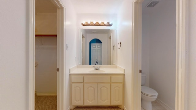 16410 Bluff Springs Dr, Houston, TX 77095 - bathroom featuring vanity, a spacious closet, tile patterned flooring, visible vents, and toilet