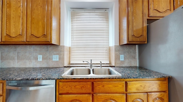 16410 Bluff Springs Dr, Houston, TX 77095 - kitchen with tasteful backsplash, a sink, dark countertops, brown cabinetry, and stainless steel appliances