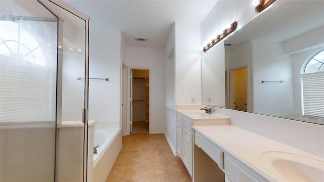 16410 Bluff Springs Dr, Houston, TX 77095 - bathroom featuring double vanity, tile patterned floors, visible vents, a bath, and a sink