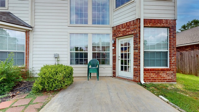 16410 Bluff Springs Dr, Houston, TX 77095 - property entrance featuring a patio, fence, and brick siding