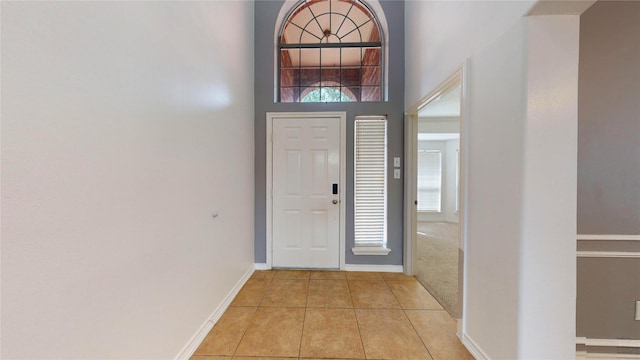 16410 Bluff Springs Dr, Houston, TX 77095 - entrance foyer featuring light tile patterned floors, baseboards, plenty of natural light, and a towering ceiling