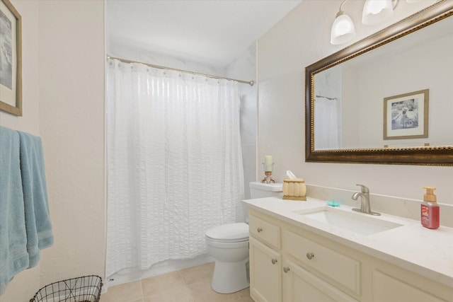 bathroom featuring toilet, vanity, and tile patterned flooring