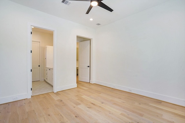 unfurnished bedroom with light wood-style floors, visible vents, and baseboards