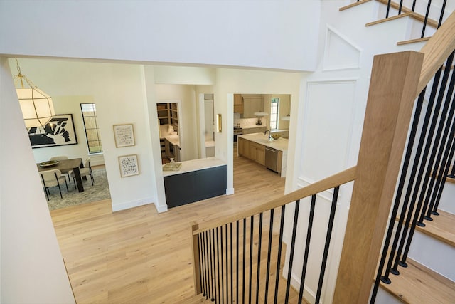 staircase with baseboards and wood finished floors