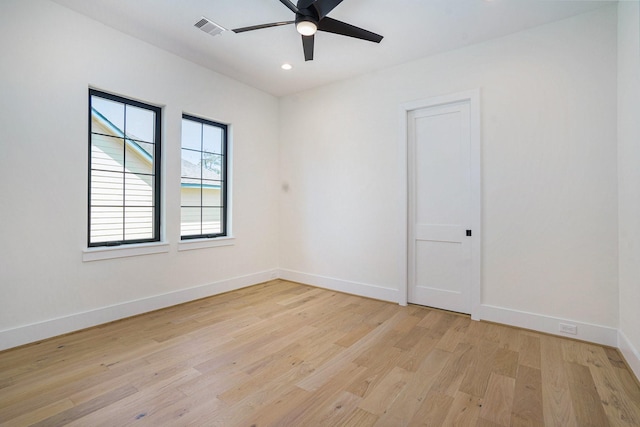 spare room featuring ceiling fan, light wood-style flooring, visible vents, recessed lighting, and baseboards