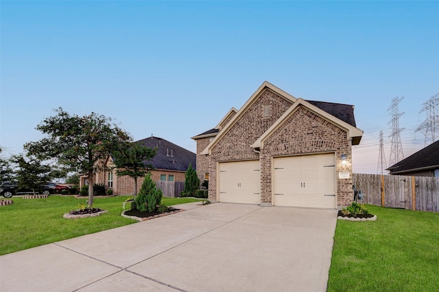 8719 Seguin Cove Ln, Richmond, TX 77407 - view of front of home featuring concrete driveway, fence, a front lawn, and brick siding