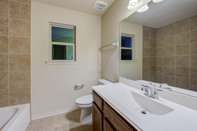 8719 Seguin Cove Ln, Richmond, TX 77407 - full bathroom with visible vents, baseboards, toilet, vanity, and tile patterned flooring