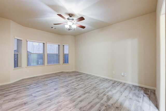 8719 Seguin Cove Ln, Richmond, TX 77407 - empty room with light wood-style floors, baseboards, a ceiling fan, and visible vents