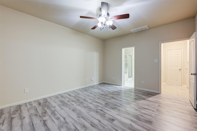 8719 Seguin Cove Ln, Richmond, TX 77407 - empty room with visible vents, light wood-type flooring, baseboards, and ceiling fan