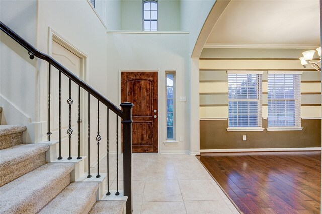 8719 Seguin Cove Ln, Richmond, TX 77407 - tiled foyer with a high ceiling, baseboards, a notable chandelier, and stairs