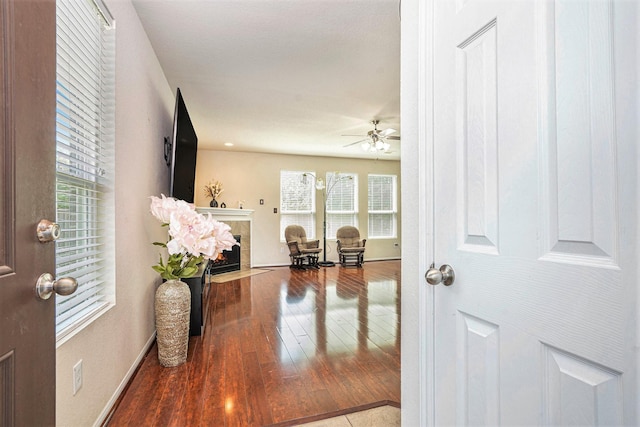 5318 El Tigre Ln, Baytown, TX 77521 - entrance foyer with a tiled fireplace, baseboards, a ceiling fan, and hardwood / wood-style floors