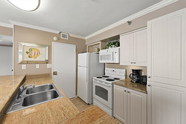 5220 Seawall Blvd Unit 1134C, Galveston, TX 77551 - kitchen with crown molding, visible vents, white appliances, a sink, and light wood-style flooring