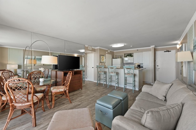 5220 Seawall Blvd Unit 1134C, Galveston, TX 77551 - living room with ornamental molding and light wood-style flooring