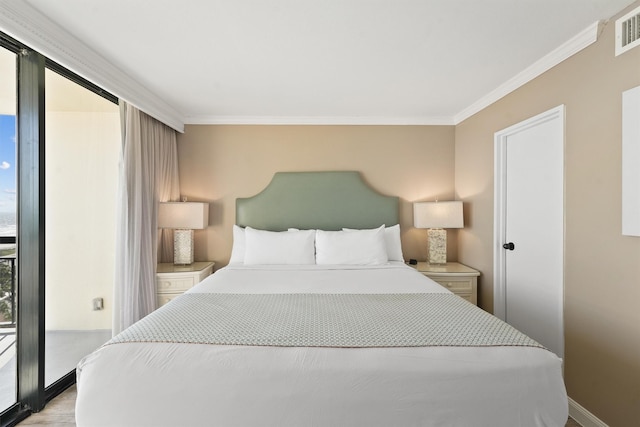 5220 Seawall Blvd Unit 1134C, Galveston, TX 77551 - bedroom featuring crown molding, light wood-style flooring, baseboards, and access to outside