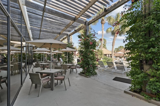 5220 Seawall Blvd Unit 1134C, Galveston, TX 77551 - view of patio / terrace featuring a pergola and outdoor dining space