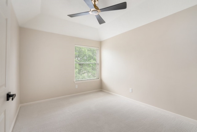 empty room featuring ceiling fan, baseboards, vaulted ceiling, and carpet