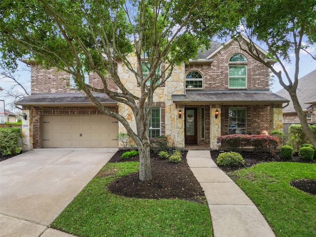 traditional-style home with driveway, stone siding, an attached garage, brick siding, and a shingled roof