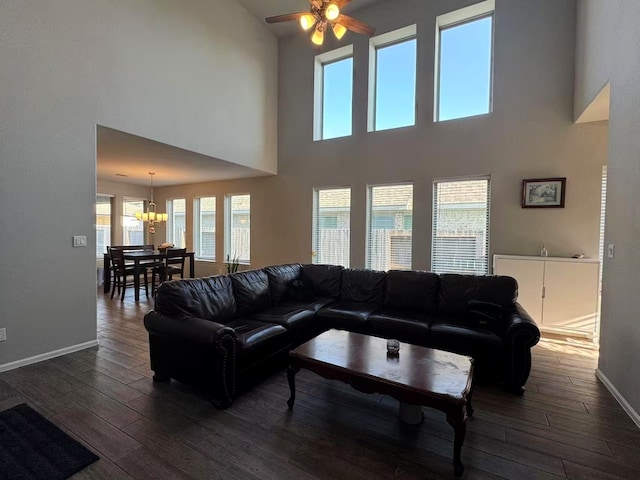 10427 Cecilia Star Ln, Richmond, TX 77406 - living room featuring wood finished floors, ceiling fan with notable chandelier, and baseboards