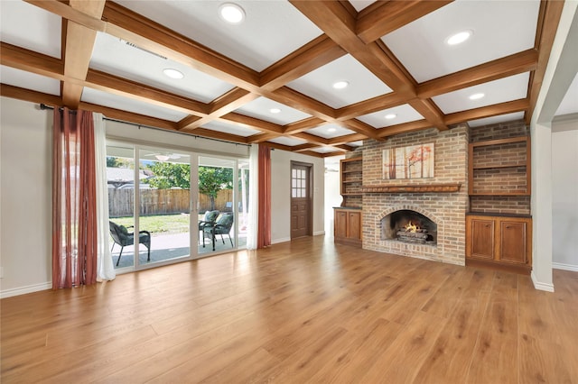 18614 Prince William Ln, Houston, TX 77058 - unfurnished living room with beamed ceiling, light wood-style flooring, a brick fireplace, and baseboards